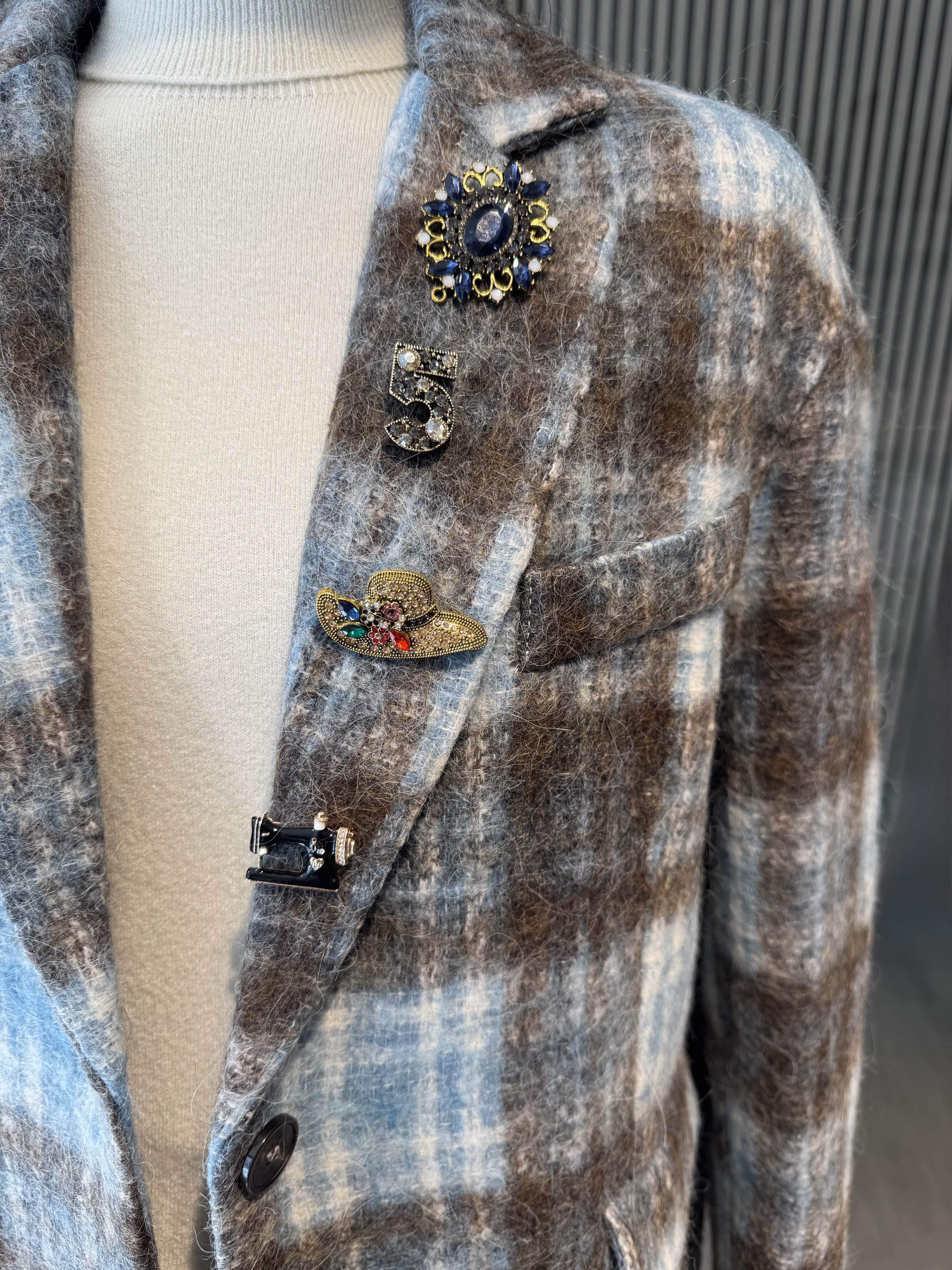 Pinstripe jacket with accessories on lapel