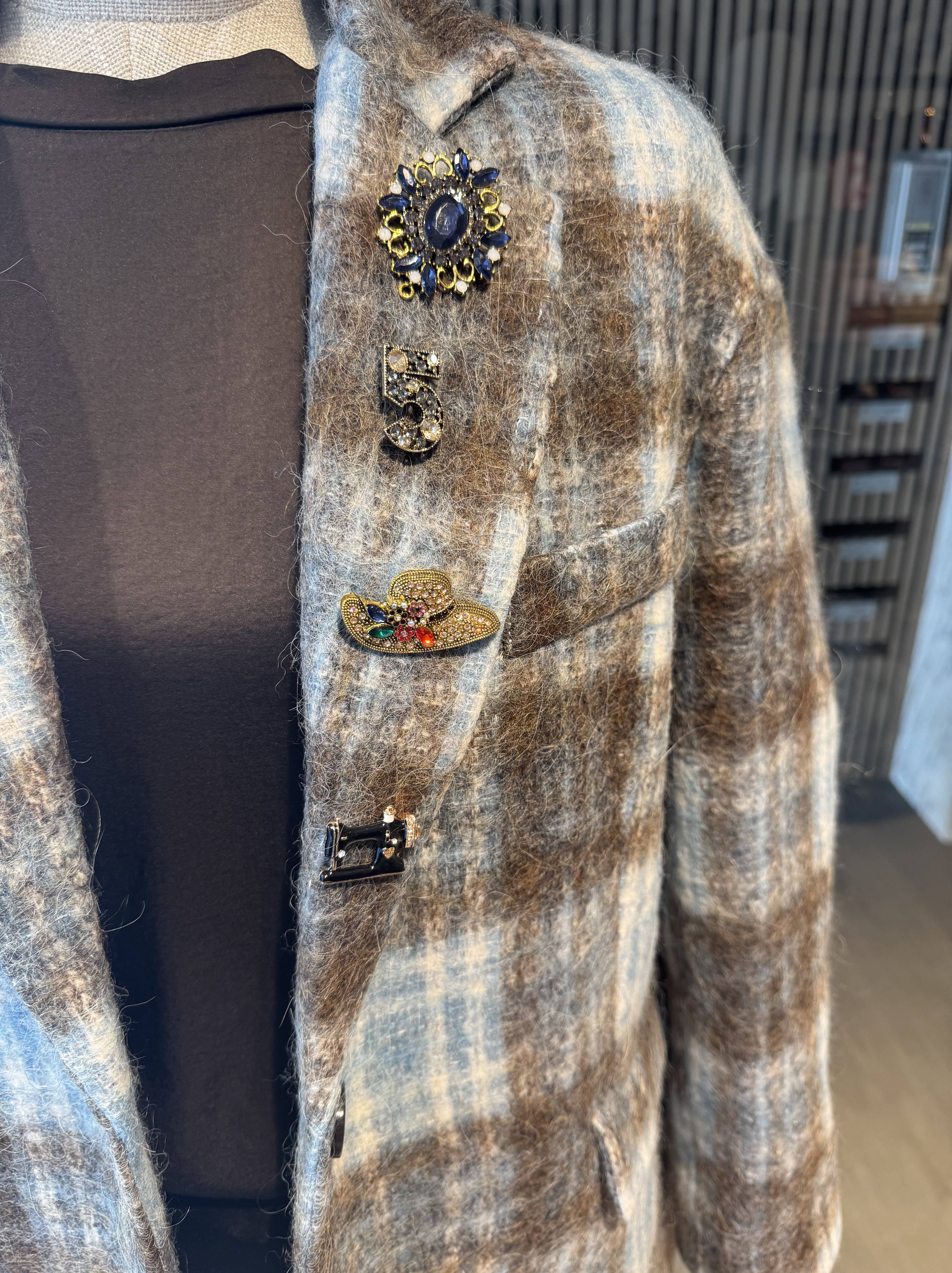 Pinstripe jacket with accessories on lapel